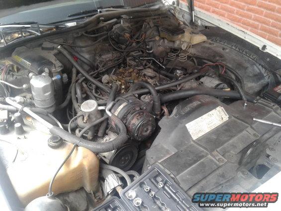 Engine bay with tools and a coolant reservoir