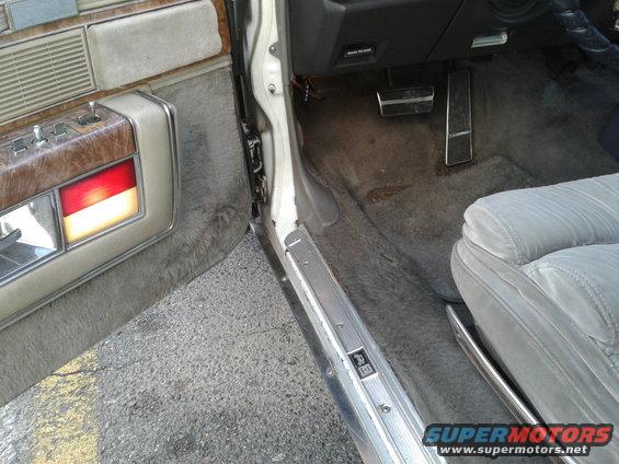 1984 Buick Electra interior door panel with wood trim and illuminated red and amber lights