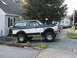 1994 Ford Bronco - This two-tone green and white Ford Bronco is shown from the side, BFGoodrich tires and a lifted suspension.