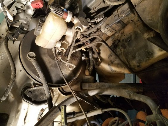 Brake master cylinder and booster assembly with various hoses and wiring connected