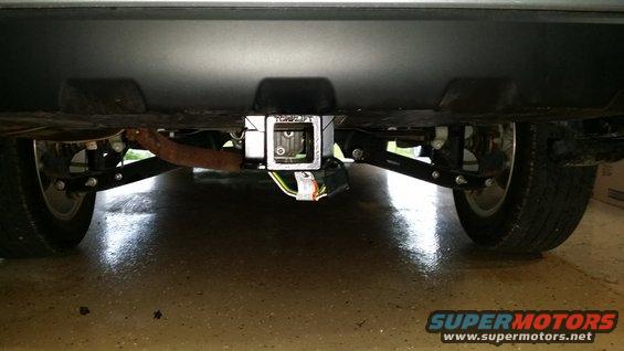 Rear trailer hitch assembly and suspension components of a vehicle