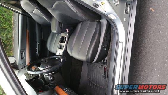 2014 Subaru Outback interior showing front seats, steering wheel, and center console