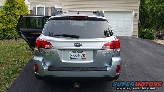 Silver 2014 Subaru Outback rear view with open driver's side door