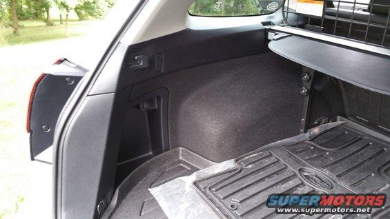 Interior cargo area with rubber floor mat and cargo cover