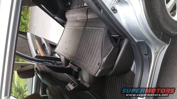 Car interior with rubber floor mats and black seats