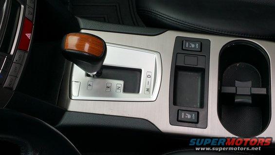 Car's center console with automatic shifter, heated seat controls, and cup holder