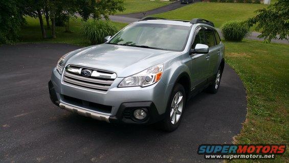 Silver Subaru Outback parked on a driveway. Front quarter view