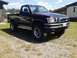 1993 Toyota Pickup/SR5 - This black 1993 Toyota Pickup/SR5 features a prominent brush guard on its front end.