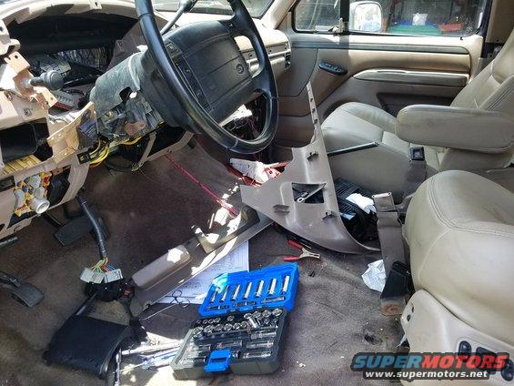 1994 Ford Bronco interior with dashboard removed, tools on floor