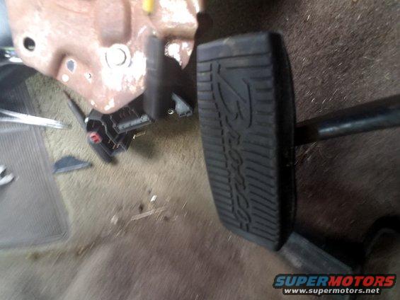 Close-up of brake and gas pedals in a vehicle. The brake pedal has the word 'Ford' embossed on it