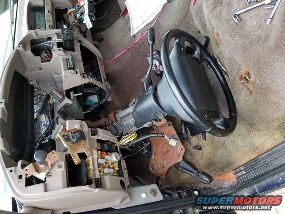 Disassembled 1994 Ford Bronco interior showing dashboard and steering column removed