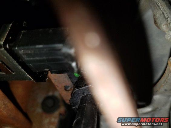 Close-up of wiring harness and connectors under a vehicle's dashboard