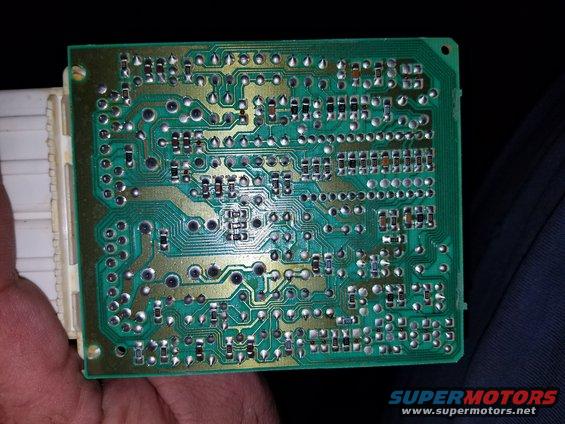 circuit board with many components and a white connector