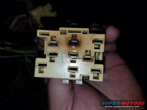 Burned electrical relay socket with cracked plastic housing and exposed wires