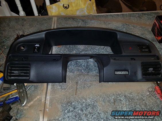 Dashboard removed from a vehicle, showing vents, switches, and a cutout for the radio