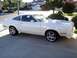 1978 Ford Mustang II - This white coupe is parked in a suburban driveway on a sunny day.