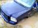 1989 Ford Bronco - This blue pickup truck is deeply stuck in a muddy area, with its front end submerged.