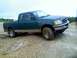 1989 Ford Bronco - This green Ford F-150 pickup truck is shown from a three-quarter front angle on a dirt terrain.
