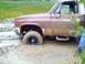 1989 Ford Bronco - This truck is really stuck in the mud, with only the side visible.
