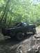 1989 Ford Bronco - Modified 1989 Ford Bronco navigating a dirt trail in a wooded area.