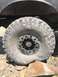1989 Ford Bronco - This image focuses on a off-road tire and wheel assembly, likely modified for extreme terrain.