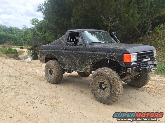Black 1989 Ford Bronco with large off-road tires and snorkel