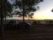 1989 Ford Bronco - Several SUVs and trucks, including a 1989 Ford Bronco, are parked in a field during a sunrise event.