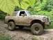 1989 Ford Bronco - This SUV is covered in mud after driving off-road through a wooded area.