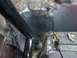 1989 Ford Bronco - The interior floor of a vehicle shows signs of rust and recent welding work.
