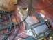 1989 Ford Bronco - The interior floor pan shows evidence of welding repairs, with a football and cables present.