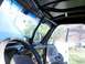 1989 Ford Bronco - The interior of a vehicle is shown, a roll cage structure and a view through the windshield.