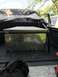 1989 Ford Bronco - A diamond plate toolbox sits in the bed of a truck, with another vehicle partially visible in the background.