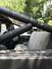 1989 Ford Bronco - Roll cage and seats inside a vehicle, with a steering wheel visible.