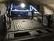 1989 Ford Bronco - The interior of a truck bed is shown, a roll cage and freshly applied spray-on liner.