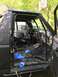 1989 Ford Bronco - The interior of a black 1989 Ford Bronco is shown with its seats removed and wiring exposed.