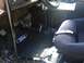 1989 Ford Bronco - The interior of a vehicle shows a Ford branded floor mat and a racing seat.