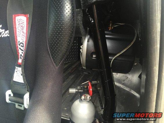 Racing seat with SFI label and a nitrous oxide bottle are visible inside a vehicle