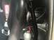 1989 Ford Bronco - Close-up view of a racing seat and a nitrous bottle mounted inside a vehicle's interior.