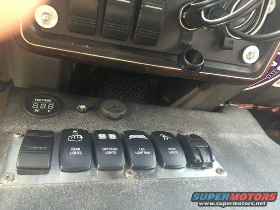 Interior dashboard with switches for rear lights, off-road lights, LED light bar, and rock lights