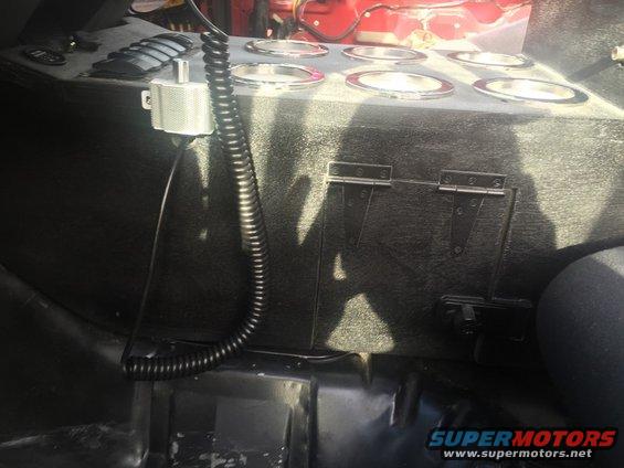 Custom center console with eight cup holders, a speaker, and hinged compartments