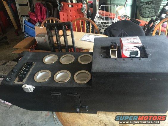 Custom center console unit with eight cup holders, multiple switches, and a box for a Tracker PT-111 device