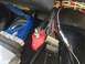 1989 Ford Bronco - Close-up view of a vehicle's complex wiring harness, showing multiple connectors and a battery terminal.