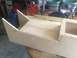 1989 Ford Bronco - A partially constructed wooden box with angled front sections is shown, possibly a custom build or part.