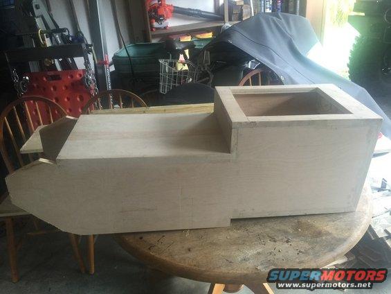 Unfinished wooden center console with a raised section