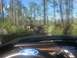 1989 Ford Bronco - A 1989 Ford Bronco navigates a wooded trail, with another vehicle visible in the distance.