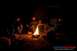 1989 Ford Bronco - A group of people enjoy a campfire at night, with a dark vehicle visible in the background.