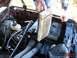1989 Ford Bronco - A person is removing a very dirty air filter from the engine compartment of a vehicle.
