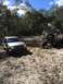 1989 Ford Bronco - A white 1989 Ford Bronco is being assisted by a silver SUV while stuck in the mud.