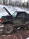 1989 Ford Bronco - A black 1989 Ford Bronco is shown with its hood open and a snorkel attachment, ready for off-road adventure in a snowy, muddy environment.