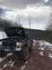 1989 Ford Bronco - Off-road Bronco on a snowy trail, hood up revealing the engine bay.